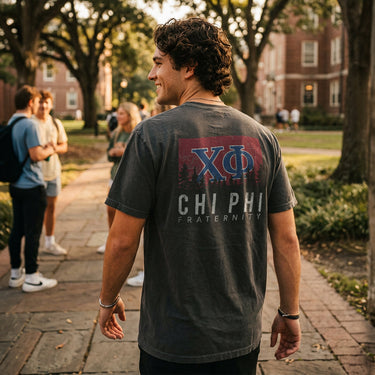 College student wearing fraternity grey t-shirt with colorful flag design on back