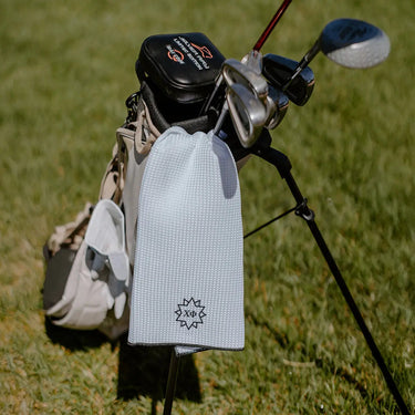 Chi Phi Greek letters embroidered on a white golf towel.